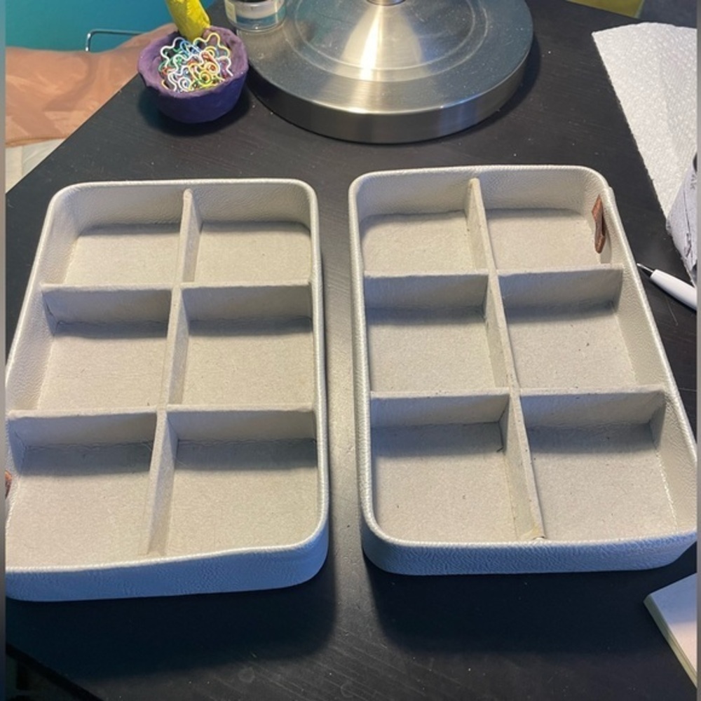 Two gray velvet jewelry display cases